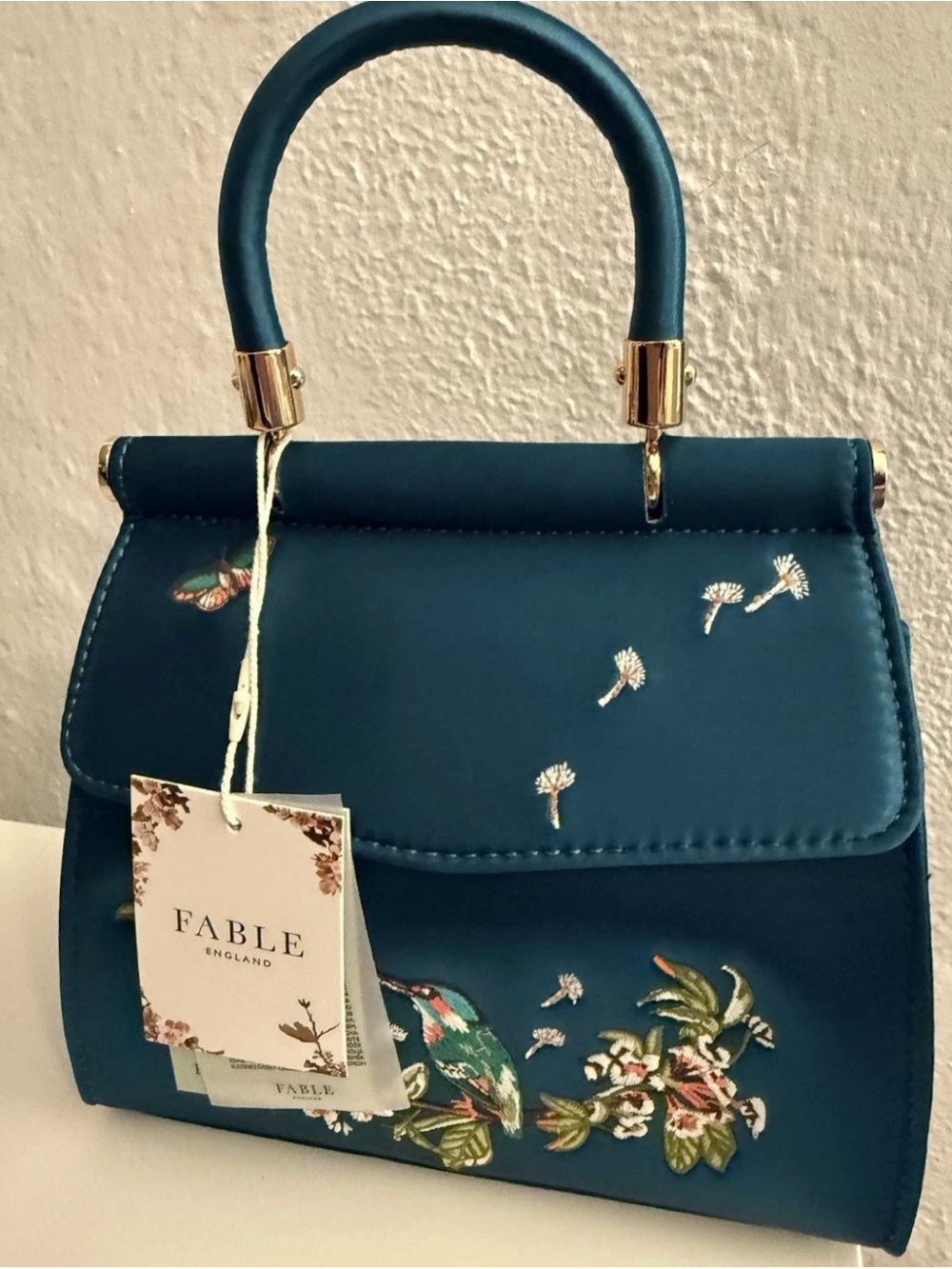 Fable England dark green mini handbag with embroidered design.